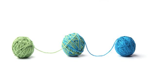 istock Colorful cotton thread balls from two color green and blue thread isolated on white background. 1067602752