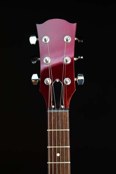 istock electric guitar head, black background 1067603022