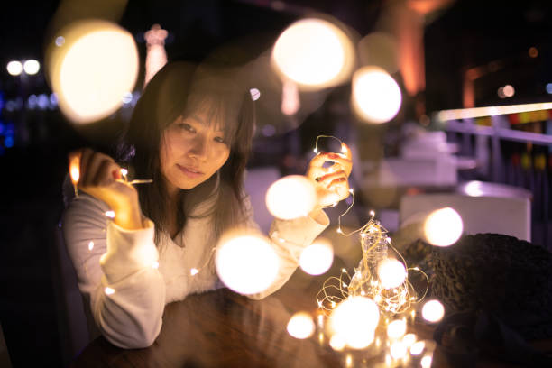 istock Woman relaxing in open cafe at night 1067604344