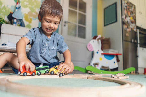 istock Cute little boy playing with wooden train 1067607912