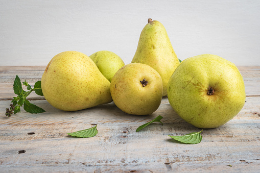 A bowl of pears on a black background