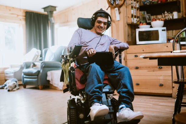 confident young man in wheelchair at home - motorized wheelchair audio imagens e fotografias de stock