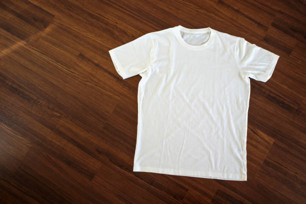 istock White t-shirt on wood background 1067622146