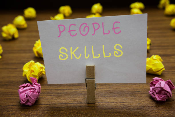 istock Handwriting text writing People Skills. Concept meaning Get Along well Effective Communication Rapport Approachable Clothespin holding white paper note crumpled papers several tries mistakes. 1067623376