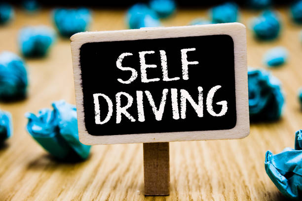 istock Handwriting text Self Driving. Concept meaning Autonomous vehicle Ability to navigate without human input Blackboard crumpled papers several tries mistake not satisfied wooden floor. 1067623510