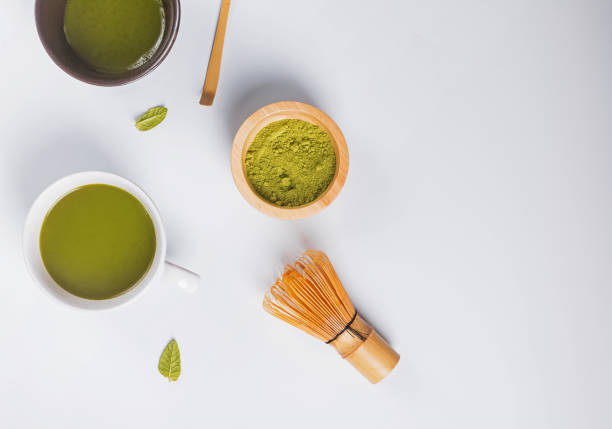istock Matcha tea in a cup, whisk and powder on the white background 1067628276
