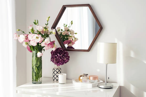 istock Light room with mirrow, flowers, night lamp and other objects 1067629556