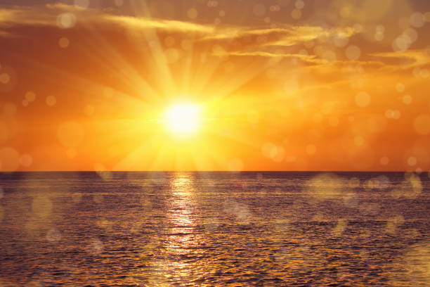 istock seascape with shiny sea over cloudy sky and sun during sunset 1067631968