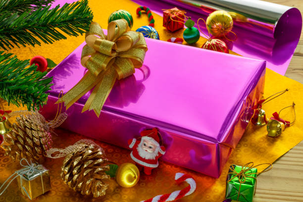 istock Gift box with bow on top and Christmas tree decoration items 1067638902