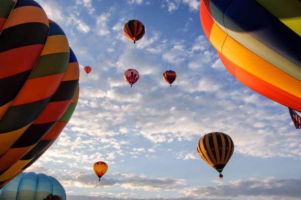 istock Hot Air Balloons Ascending Into Cloudy Sky 1067639328