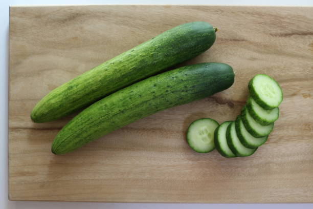 istock sliced cucumbers on wooden cutting board 1067645038