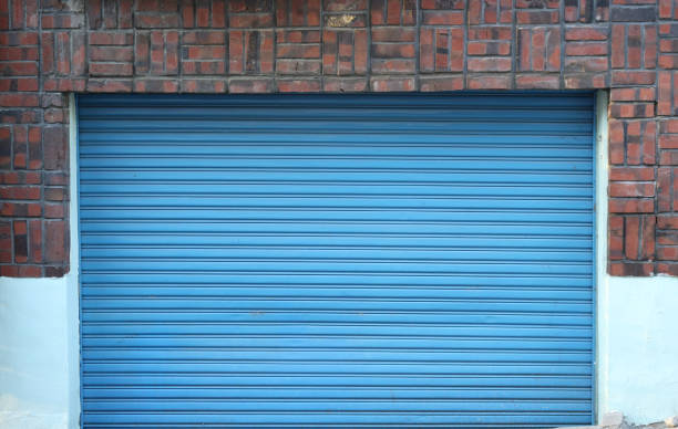 istock front view of garage with roll up door, blue color background 1067645048