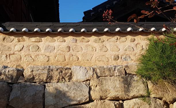 istock traditional Korean stone wall exterior and pine trees 1067645078