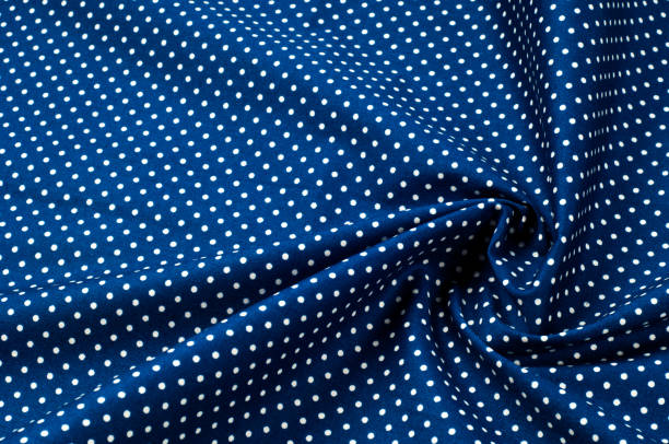 istock Texture background pattern. Abstract background of a luxurious blue fabric in white polka dots wavy folds of a grunge silk texture of a satin velvet material or a luxurious background or elegant wallpaper 1067650528