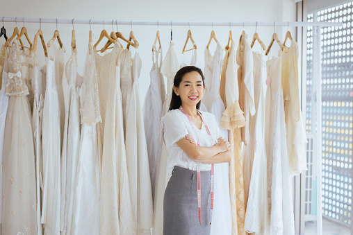 Portrait of asian woman wedding dress store owner,Beautiful dressmaker in shop and small business