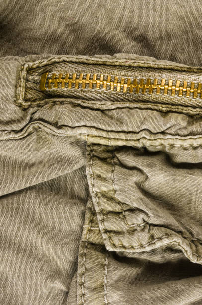 istock clothing items washed cotton fabric texture with seams, clasps, buttons and rivets 1067660914
