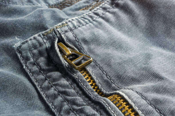 istock clothing items washed cotton fabric texture with seams, clasps, buttons and rivets 1067661212