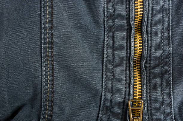 istock clothing items washed cotton fabric texture with seams, clasps, buttons and rivets 1067665736