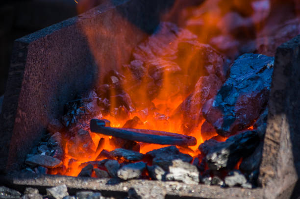 istock blacksmith furnace with burning coals, tools, and glowing hot horseshoe 1067671148