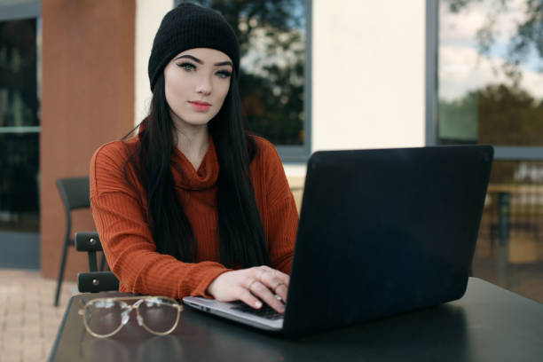 istock woman on laptop computer at coffee shop 1067673192