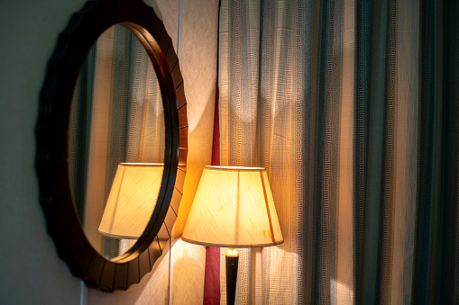 old-fashioned lamp and mirror of hotel room