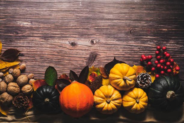 istock Happy Thanksgiving Day with pumpkin and nut on wooden table 1067673468