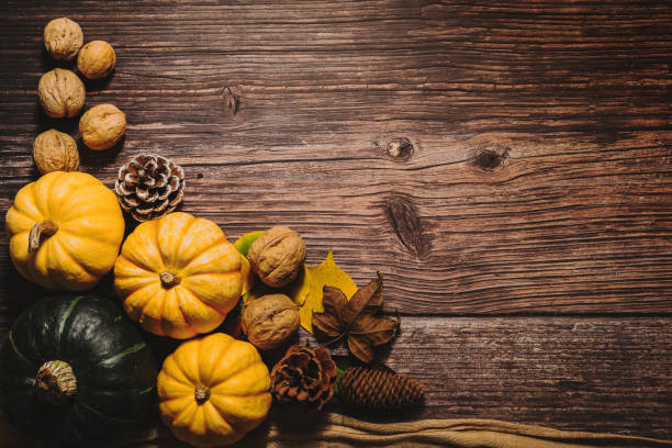 istock Happy Thanksgiving Day with pumpkin and nut on wooden table 1067673630