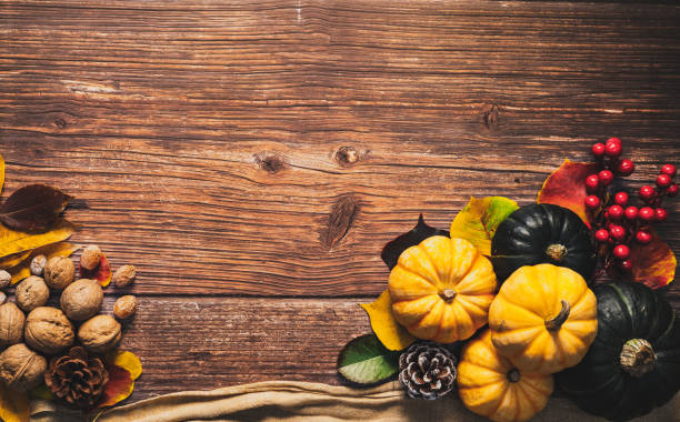 istock Happy Thanksgiving Day with pumpkin and nut on wooden table 1067674942