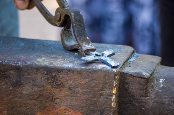istock blacksmith performs the forging of hot glowing metal on the anvil 1067674964