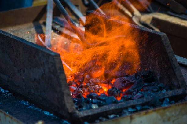 istock blacksmith furnace with burning coals, tools, and glowing hot metal workpieces 1067677386
