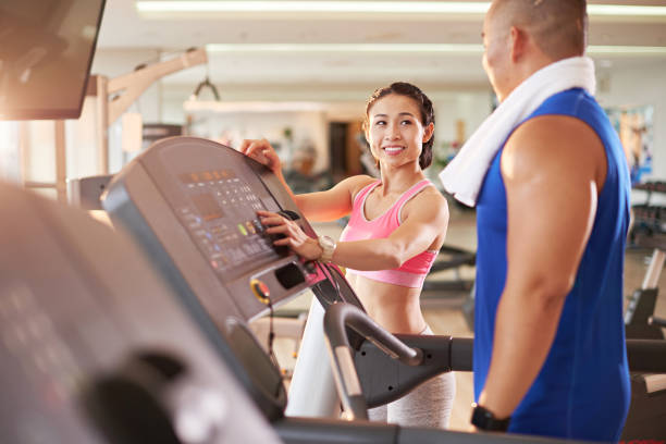 istock Female fitness trainer working with client 1067679886