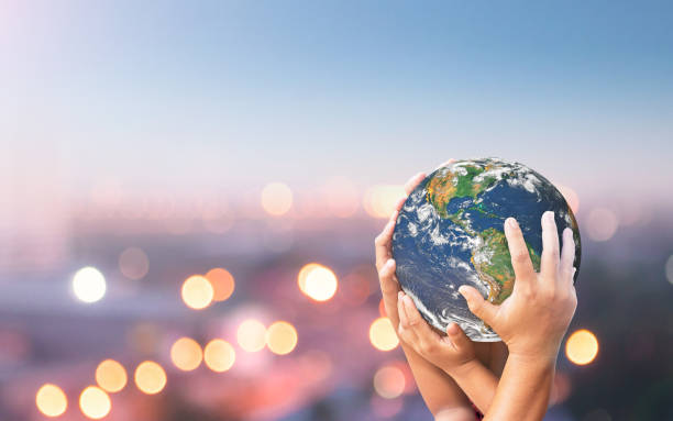 Sustainable community concept Human hands holding earth global over blurred blue nature background. Elements of this image furnished by NASA (https://earthobservatory.nasa.gov/images/885) earth in hands stock pictures, royalty-free photos & images