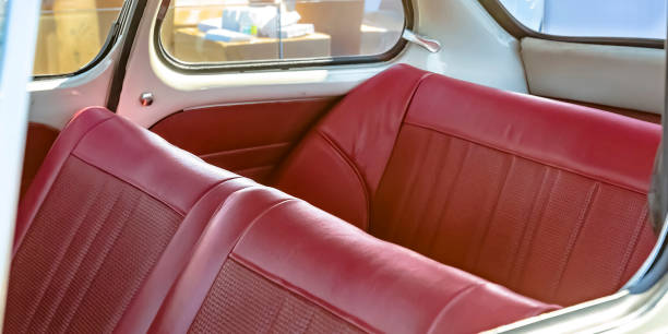 Red leather seats of an old fashioned compact car