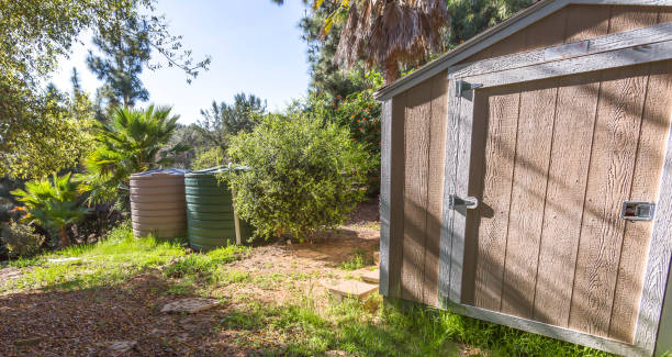 istock Wooden shed and cistern in a sunny backyard 1067686034