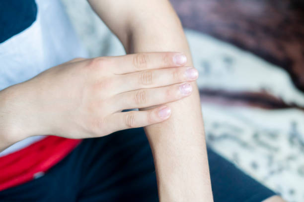 istock close up hand touch arm feeling pain f 1067694700