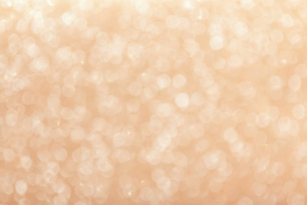 istock Blurred shiny beige background with sparkling lights. 1067696800