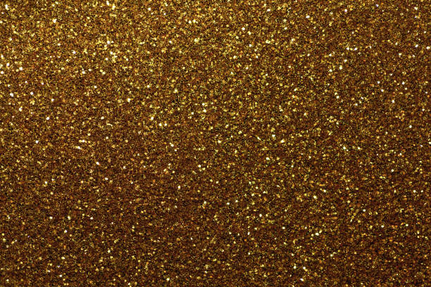 istock Dark golden sparkling background from small sequins, closeup. Brilliant backdrop. 1067703038