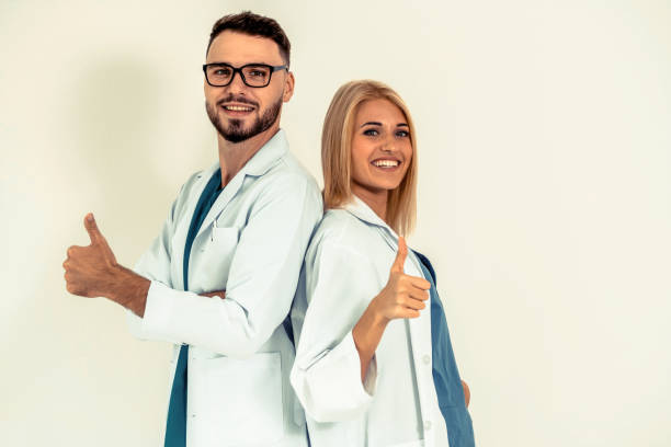 istock Portrait of confident doctors on white background. 1067716422