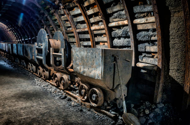 istock Coal mine underground corridor with freight railroad cars 1067723336