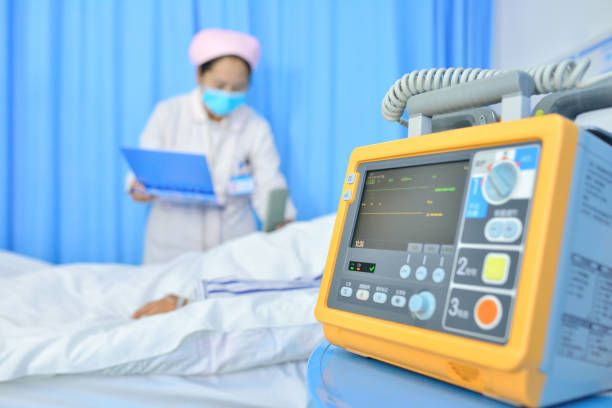 Close-up of the doctor examining with patient in hospital ward.
