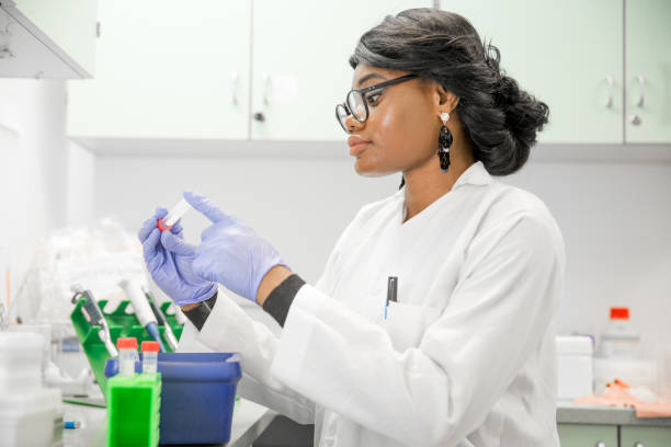 istock Female African Researcher Holding a Sample and Looking at it. 1067733148