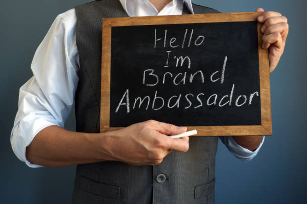 man is holding blackboard with sign i am brand ambassador. - ambassador imagens e fotografias de stock