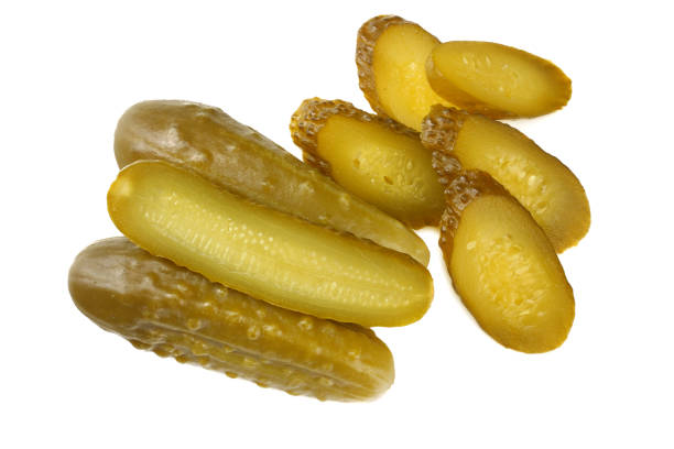 istock sliced marinated pickled cucumbers isolated on white background. top view 1067739222