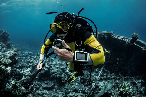 istock Scuba diver swimming with an action camera 1067743206