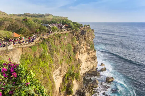 People walking on the edge of the cliffs at Ulu Watu, Bali, Indonesia