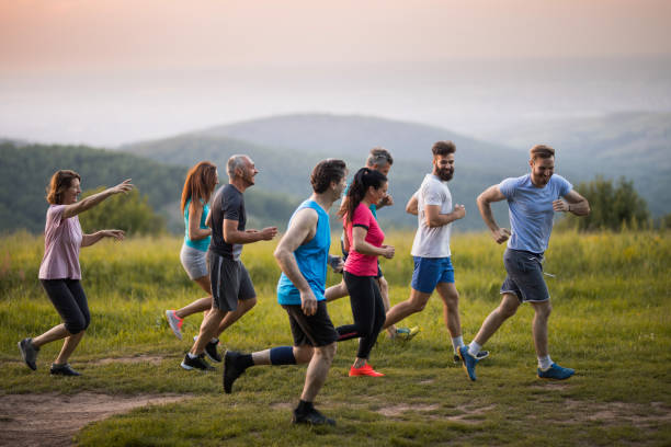 istock Group of happy mixed age people jogging in nature. 1067743738