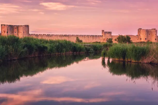 Photo of Scenic sunset view of the ancient city wall of the Aigues-Mortes, famous medieval fortress in South France