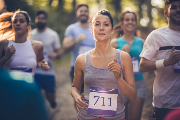 istock Female marathon runner competing on a race in nature. 1067748246