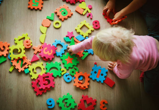 istock kids playing with puzzle, learning shapes and numbers 1067748638