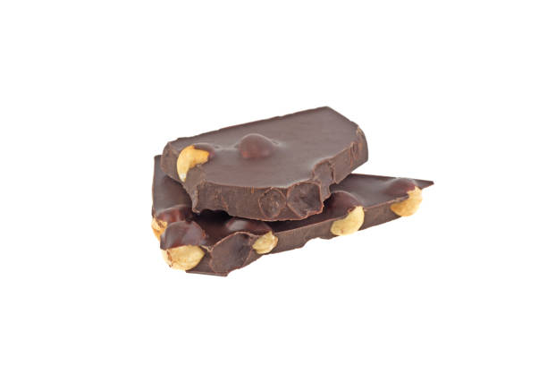 istock a piece of black chocolate with nuts isolated on white background 1067750112